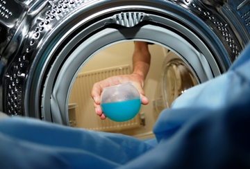 Pictured is a cool photo from the inside of a washing machine (now an indispensable home appliance) ... shows the detergent being loaded into the machine.  Courtesy of UK photographer Dave Kennard.